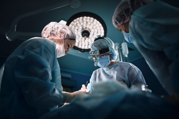 Medical team in the operating room, dark background.